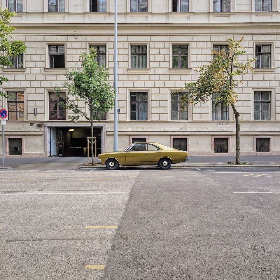 yellow sedan on concrete roadway online puzzle