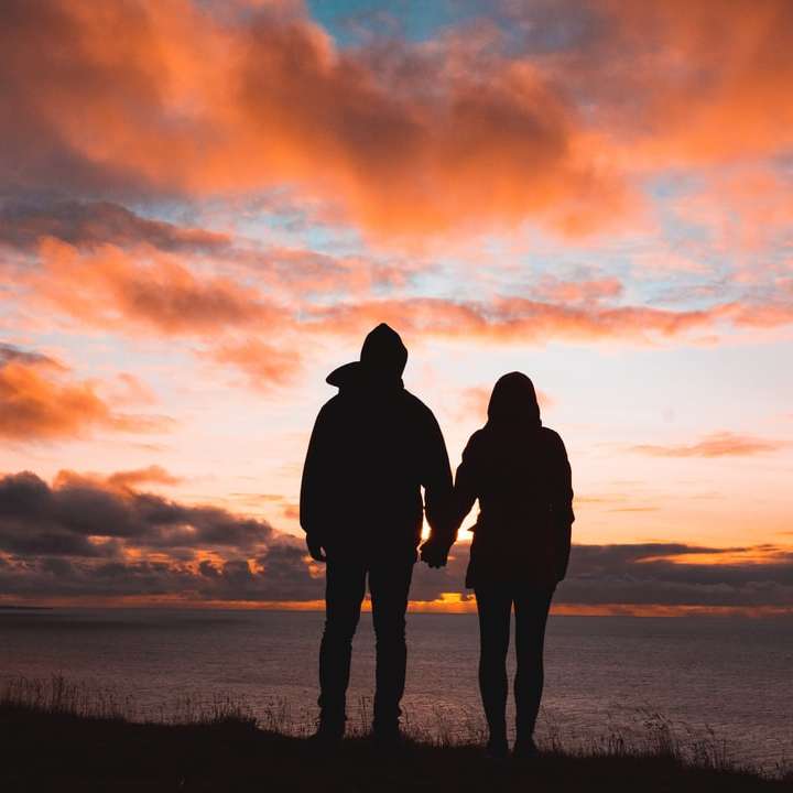Silhouette Foto von Mann und Frau auf Klippe Online-Puzzle