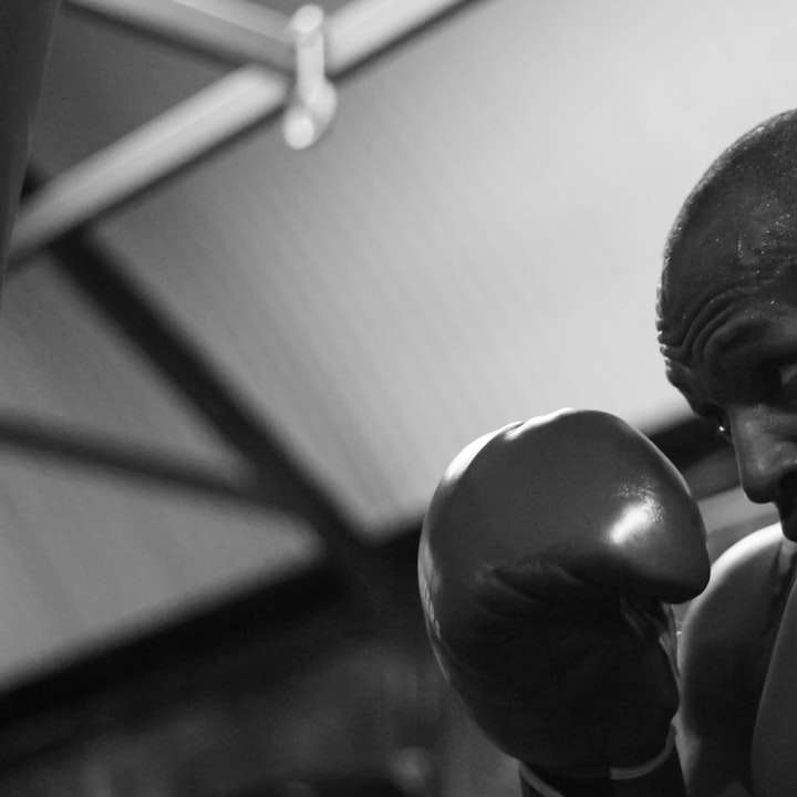 grayscale photo of man wearing boxing gloves sliding puzzle online
