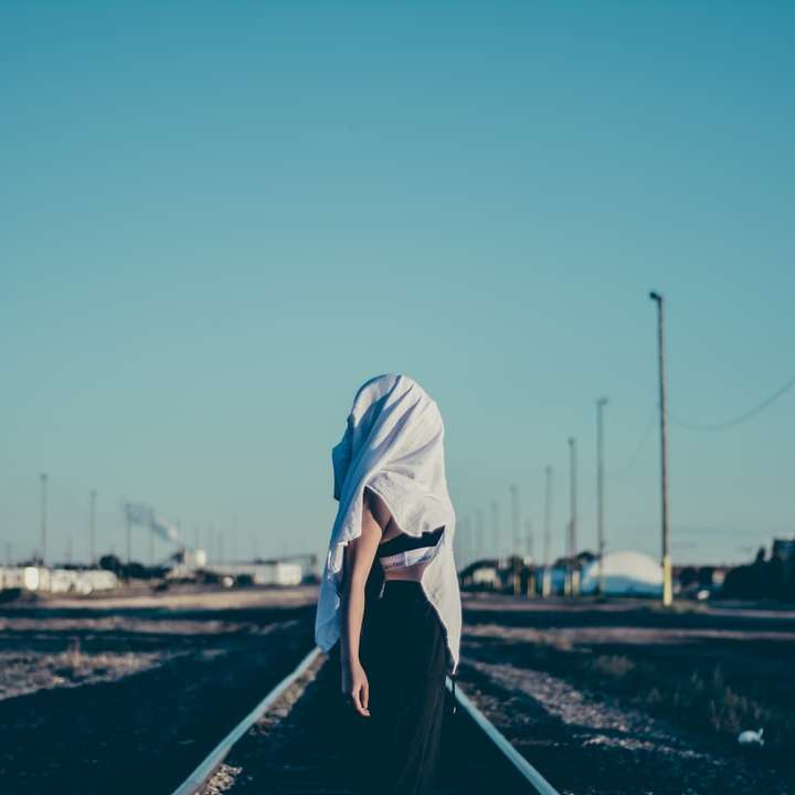 Girl standing on railway tracks sliding puzzle online