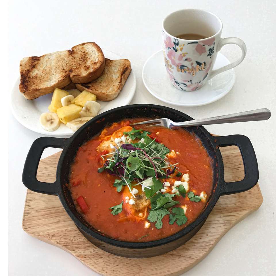 black ceramic bowl with soup beside white ceramic mug online puzzle