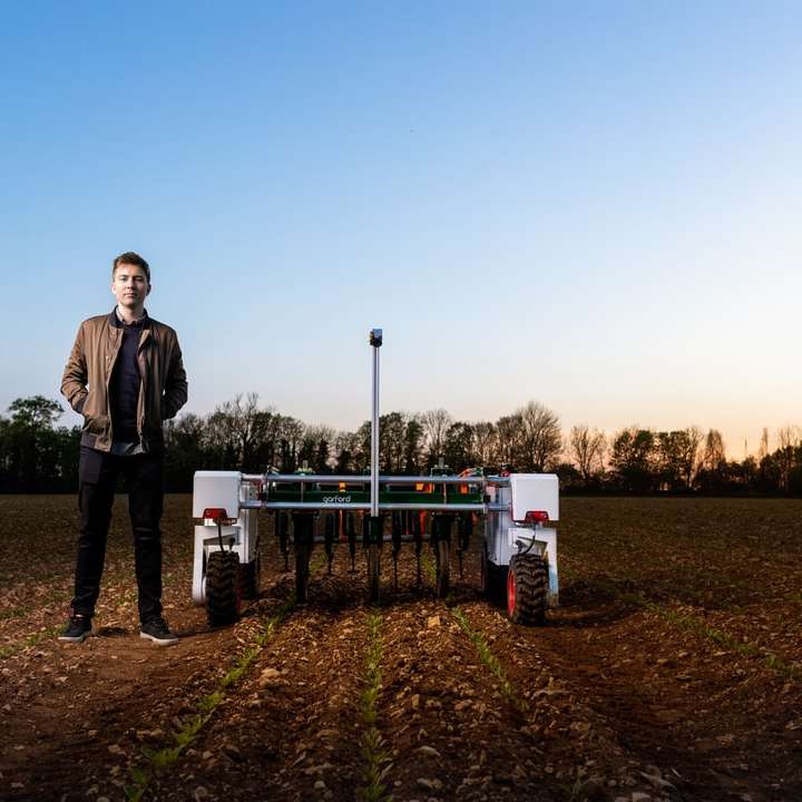 Male mechanical engineer with agricultural robot online puzzle