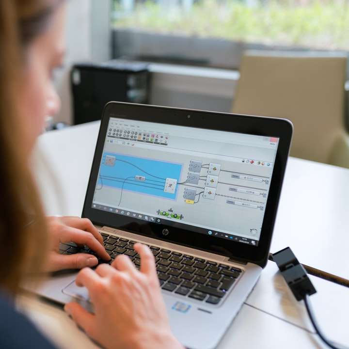 Frau im schwarzen Langarmhemd mit MacBook Pro Schiebepuzzle online
