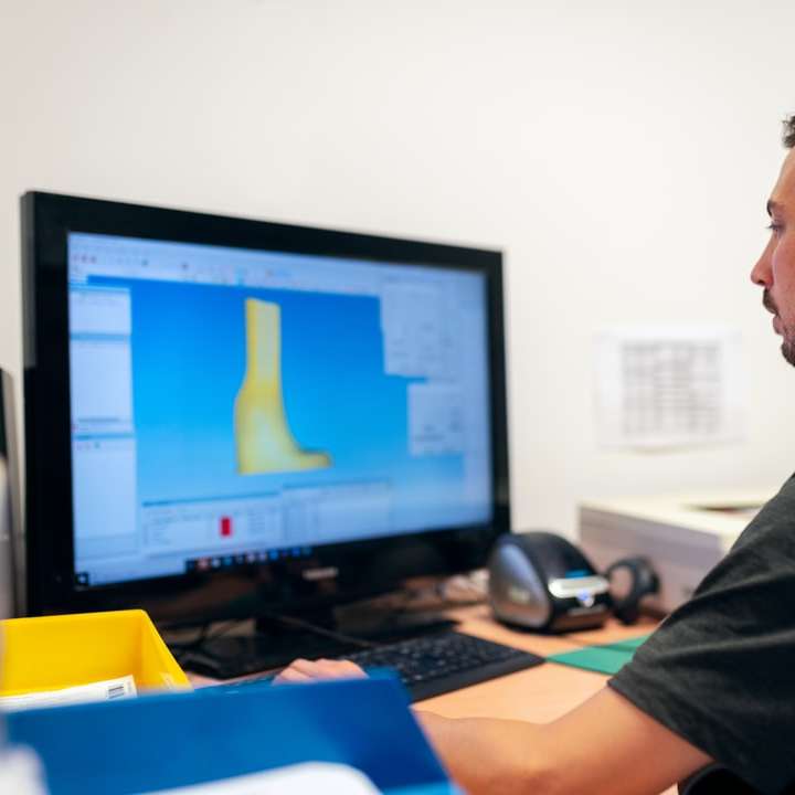 muž v černém tričku sedí v přední části počítače posuvné puzzle online