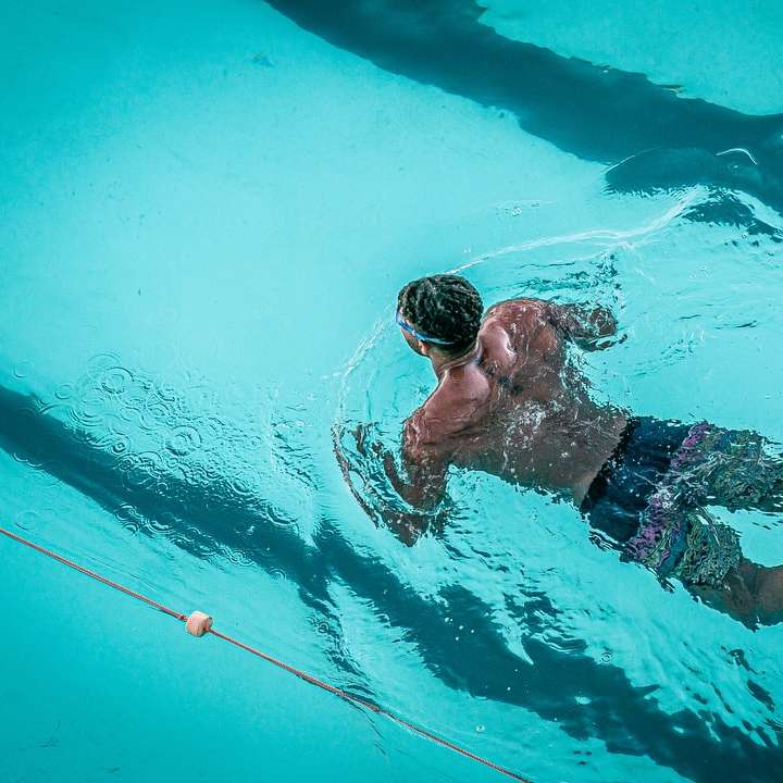 man swimming in pool sliding puzzle online