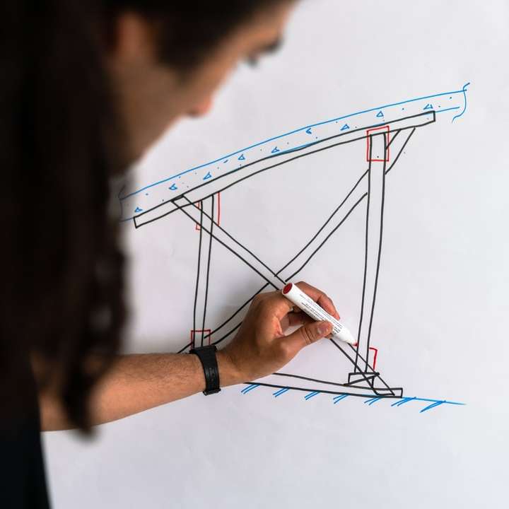 Male structural engineer draws on whiteboard online puzzle