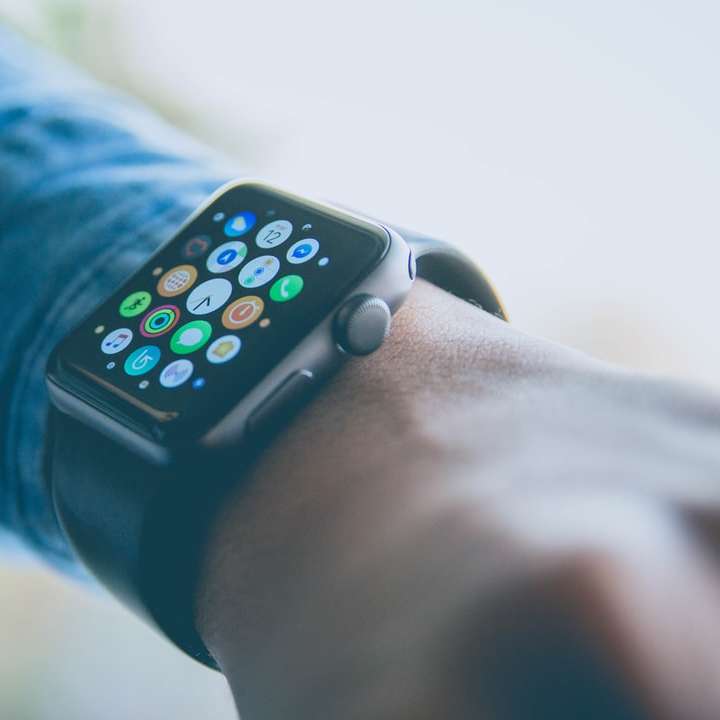 person wearing space gray aluminum case Apple Watch online puzzle