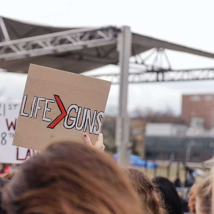 person raising life guns-printed board sliding puzzle online