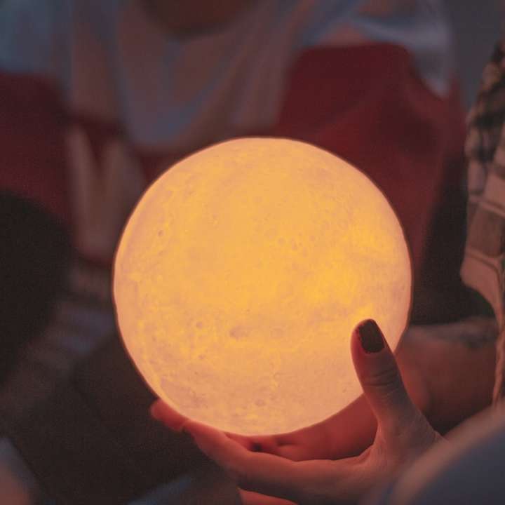 person holds lighted ball online puzzle