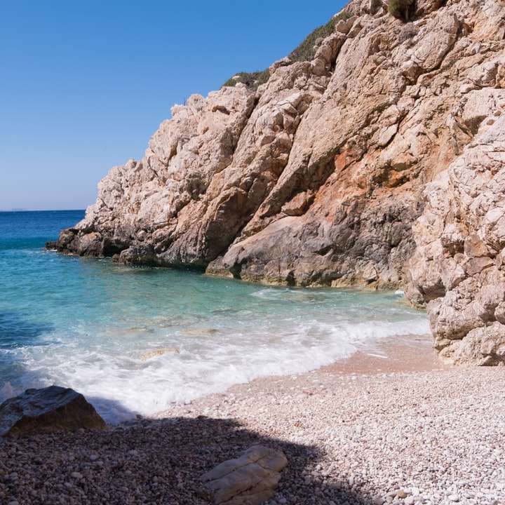 A hidden cove with turquoise water in the Mediterranean Sea sliding puzzle online