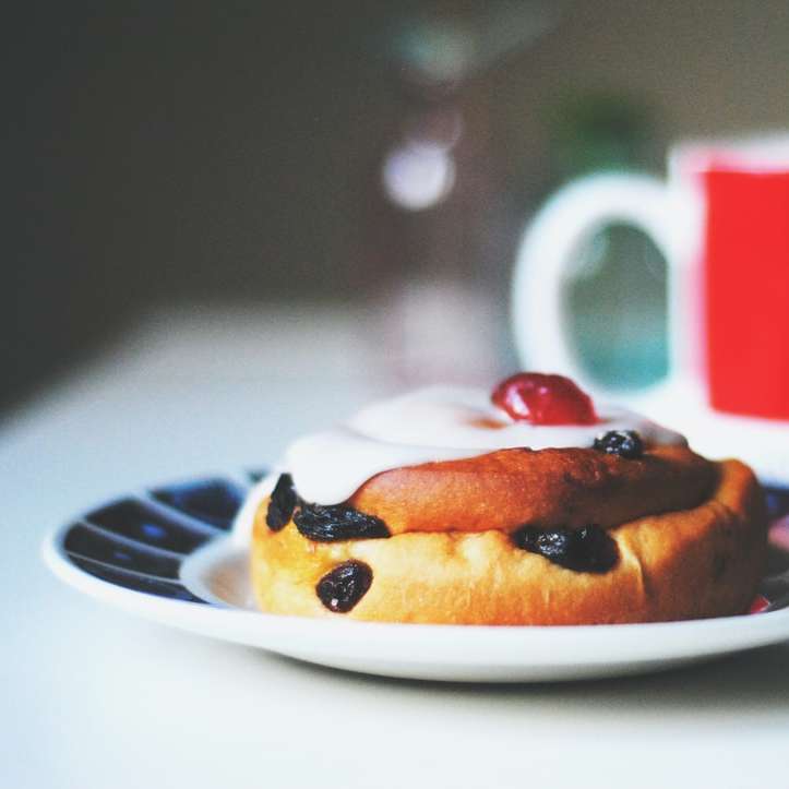 bread with raisins on saucer beside white and red mug sliding puzzle online
