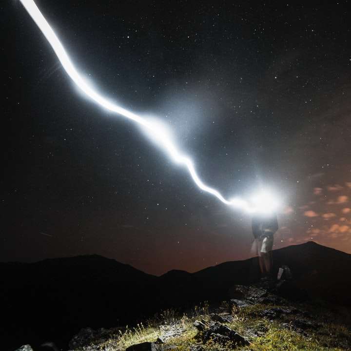 człowiek stojący na klifie w nocy puzzle przesuwne online