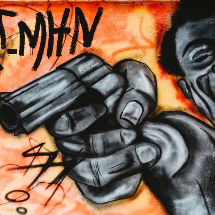 graffiti av en svart man som håller en pistol glidande pussel online