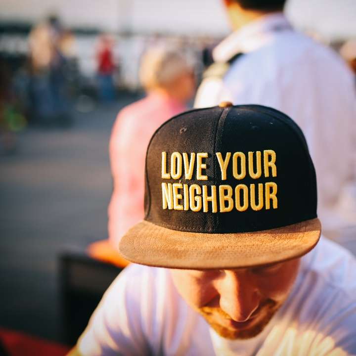 man wearing black cap with love your neighbour print online puzzle