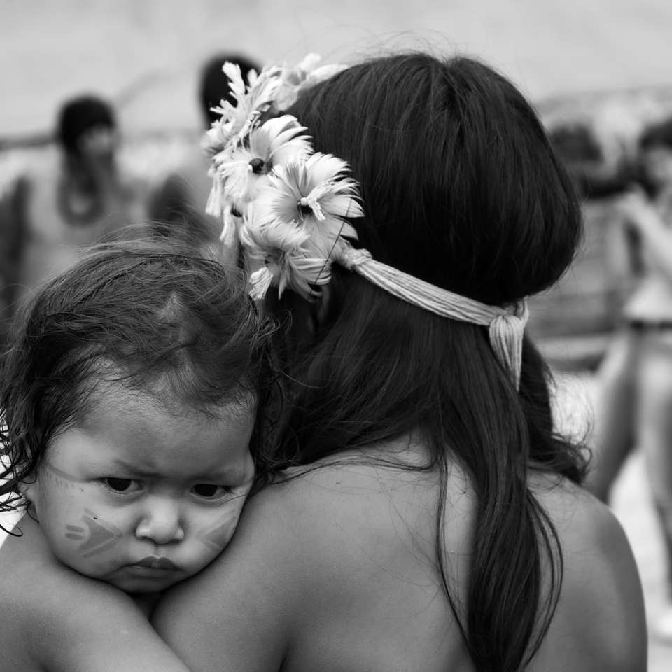 Guarani baby girl on mom's cuddle sliding puzzle online