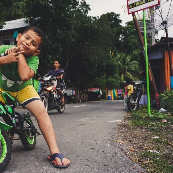 хлопчик їзда чорно-зелений велосипед біля чоловік їзда на мотоциклі розсувний пазл онлайн
