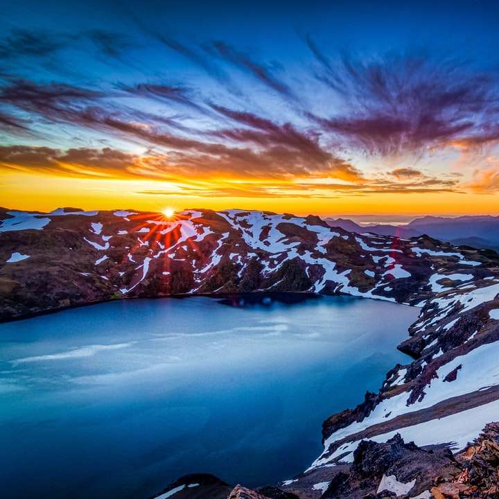 montaña cubierta de nieve durante la puesta de sol puzzle deslizante online