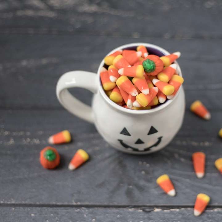 candies in mug and wooden surface sliding puzzle online