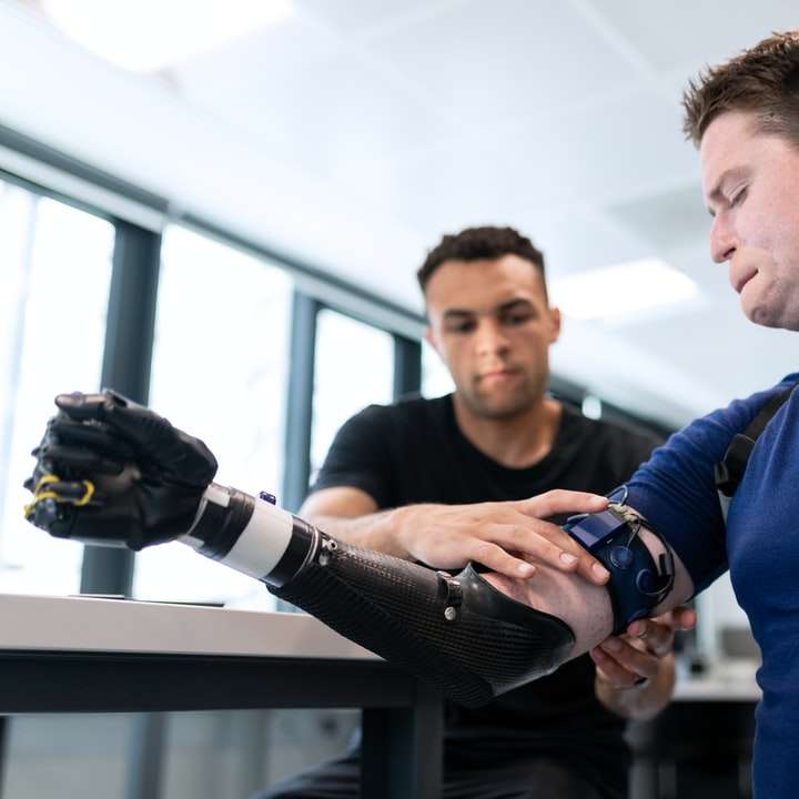 Male mechanical engineer fits prosthetic limbs online puzzle