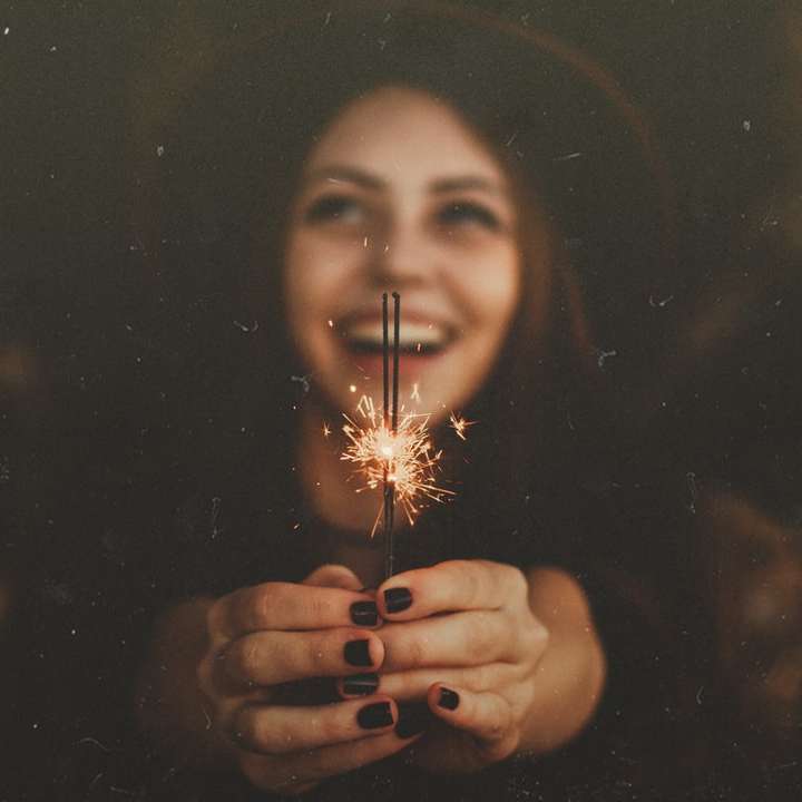 Woman holds out sparklers online puzzle