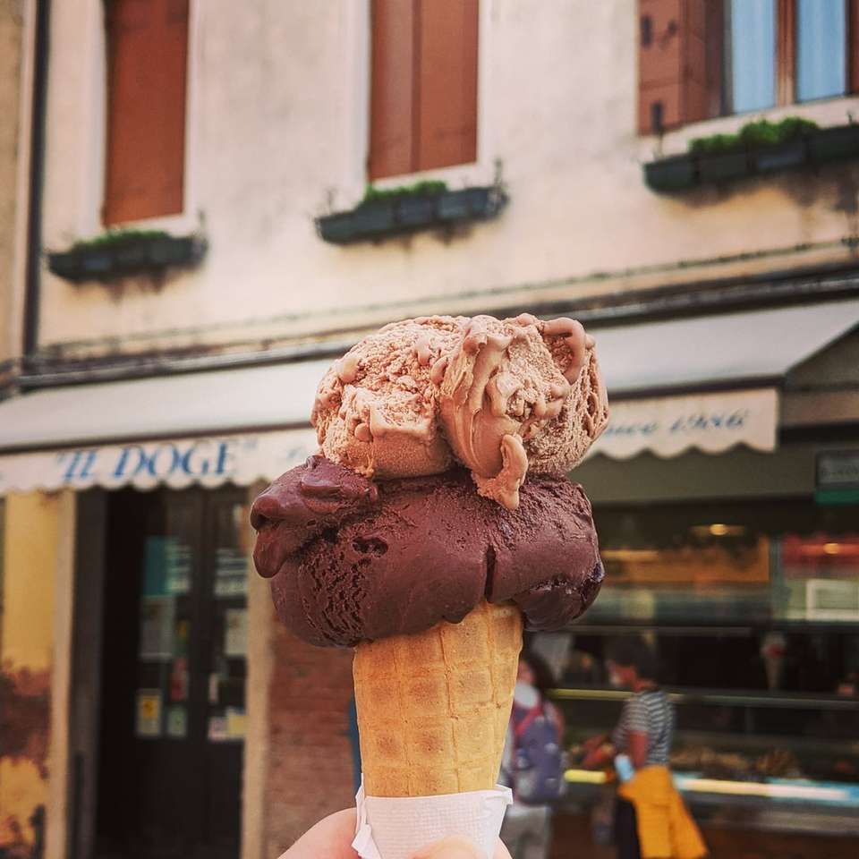човек, който държи кафяв конус за сладолед плъзгащ се пъзел онлайн