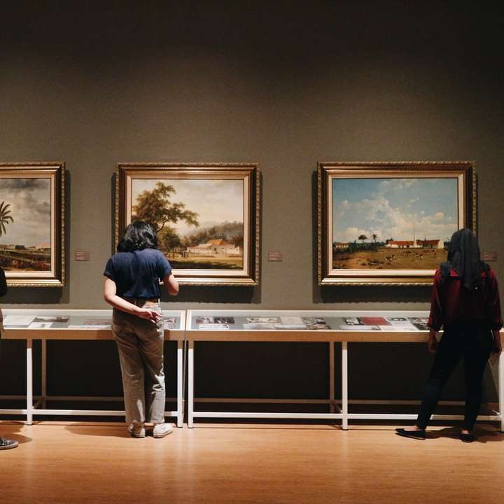 people standing in front of paintings sliding puzzle online