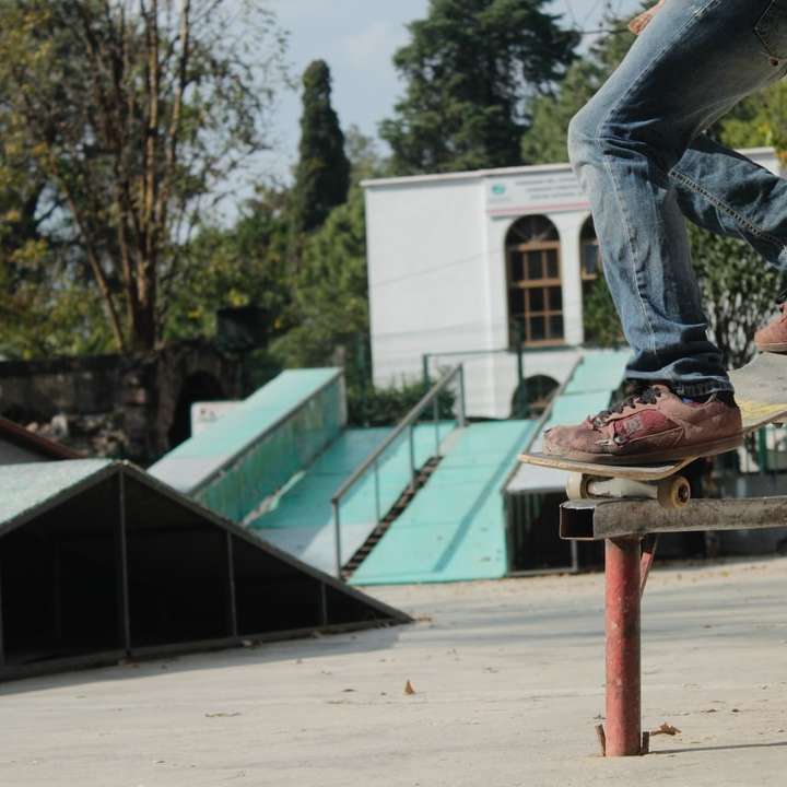 person skating on rail during daytime sliding puzzle online