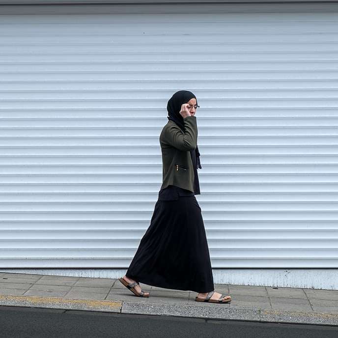 mujer caminando junto a la puerta enrollable cerrada rompecabezas en línea