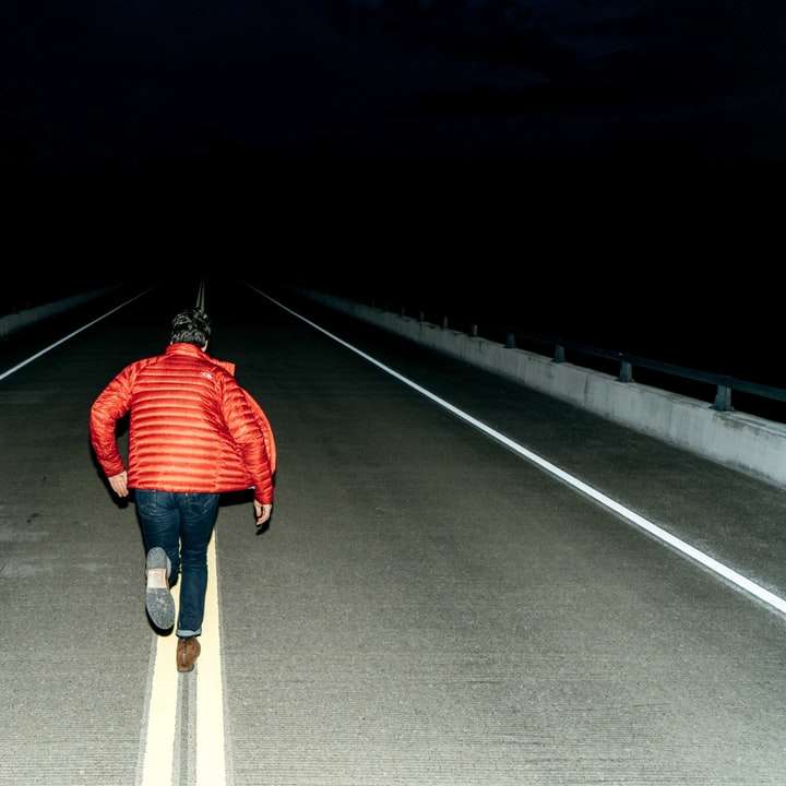 man running on road during night time online puzzle