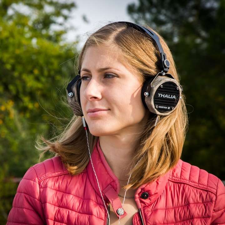 снимка с плитък фокус на жена, използваща слушалки с черен кабел онлайн пъзел