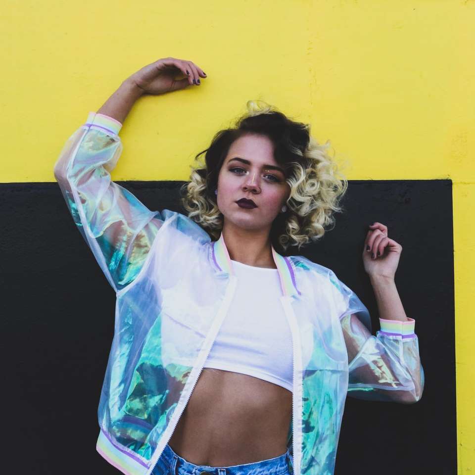 woman wearing clear plastic bomber jacket, white crop shirt online puzzle