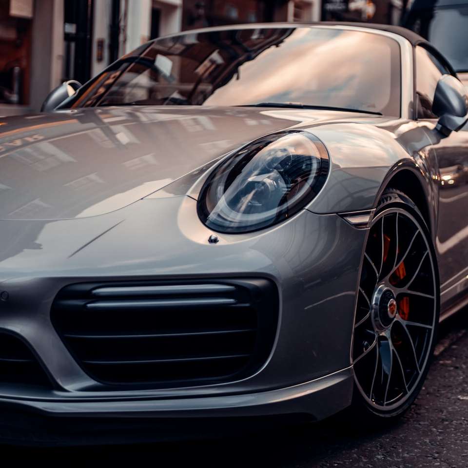silver porsche 911 parked in front of building online puzzle