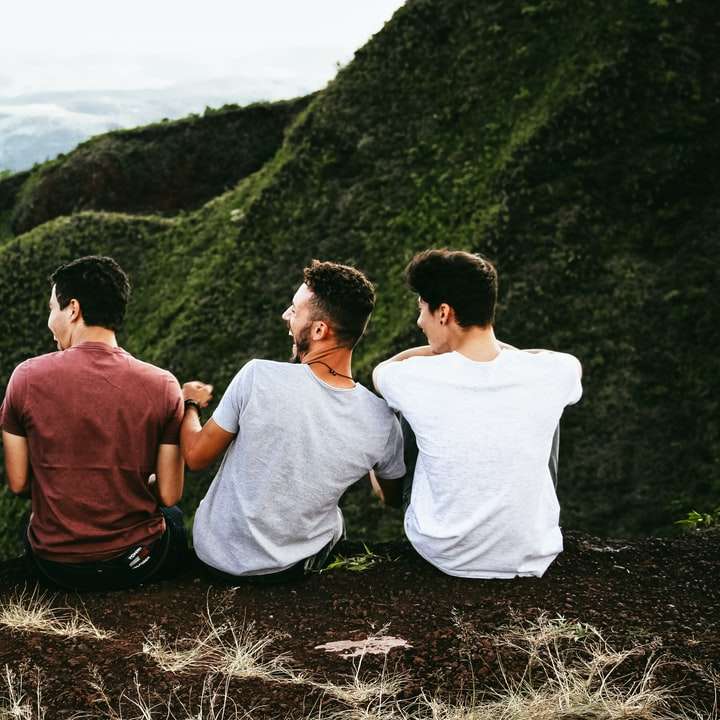 ред от четирима мъже, седнали на планинска пътека онлайн пъзел