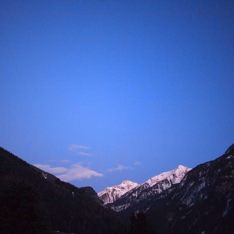 hóval borított hegyek kék ég alatt napközben online puzzle
