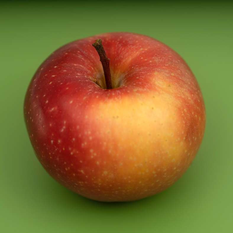 Manzana roja sobre superficie verde rompecabezas en línea