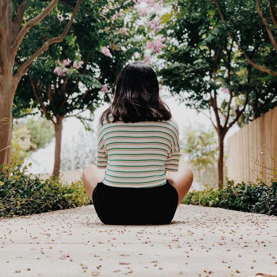 woman in white and black stripe shirt sitting on ground online puzzle