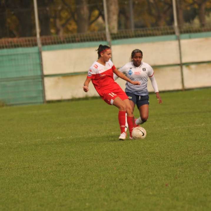 2 kvinnor i vit och röd fotboll uniform spela Pussel online