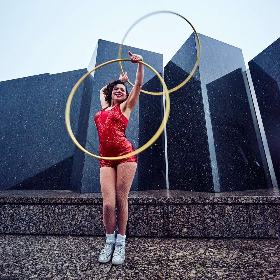 woman in red suit holding hula hoops sliding puzzle online