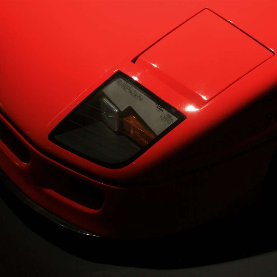 röd ferrari bil i närbild fotografi glidande pussel online