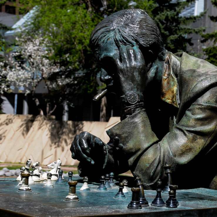 man in brown jacket statue sliding puzzle online
