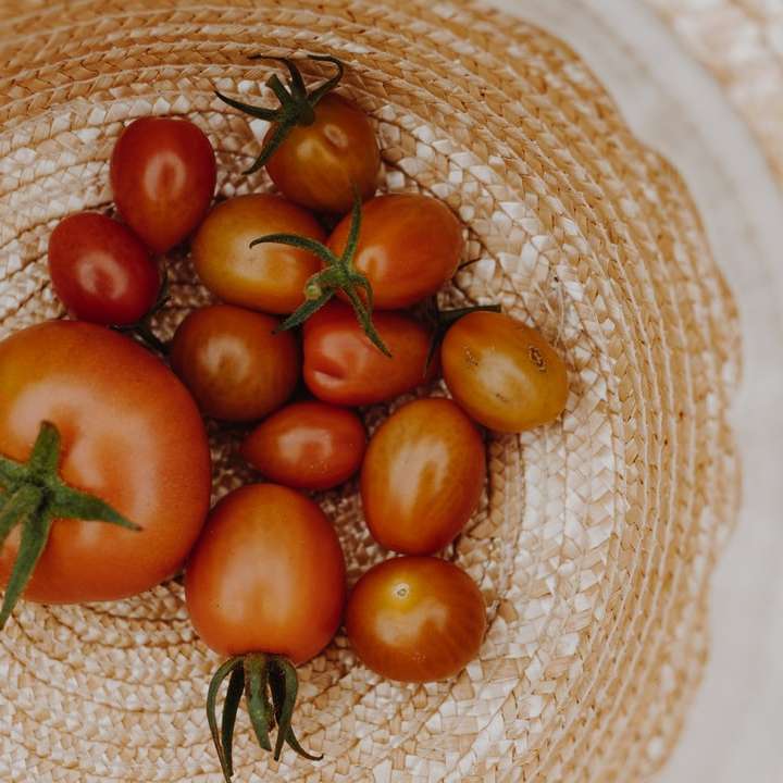 pomarańczowy i czerwony pomidor na brązowym plecionym koszu puzzle przesuwne online