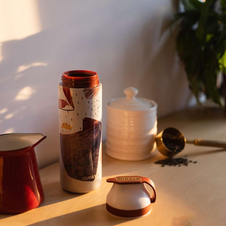 red ceramic mug beside white and brown ceramic mug online puzzle