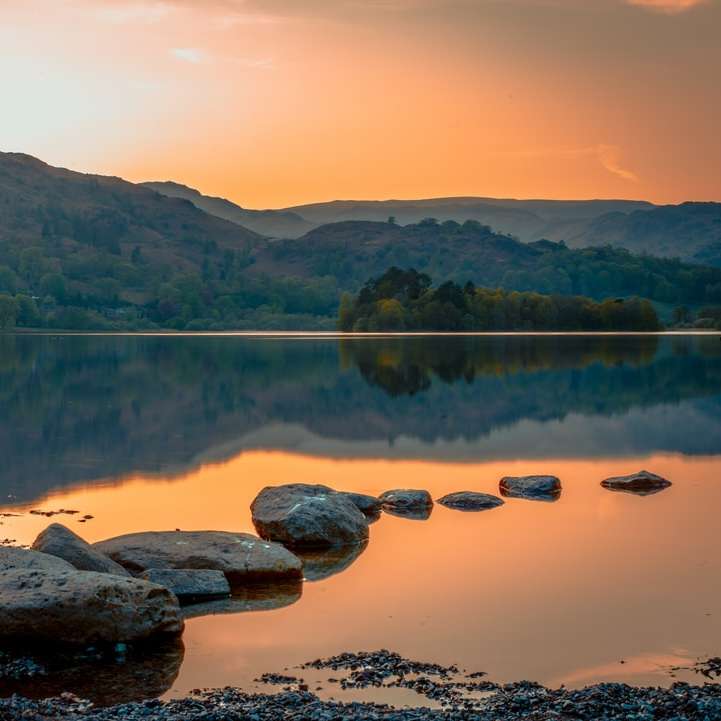 brown rocks on lake during daytime online puzzle