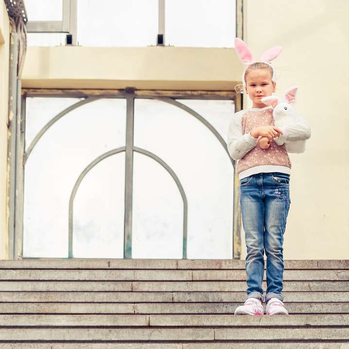 Frau in blauen Jeans und rosa Jacke, die auf Treppen stehen Schiebepuzzle online