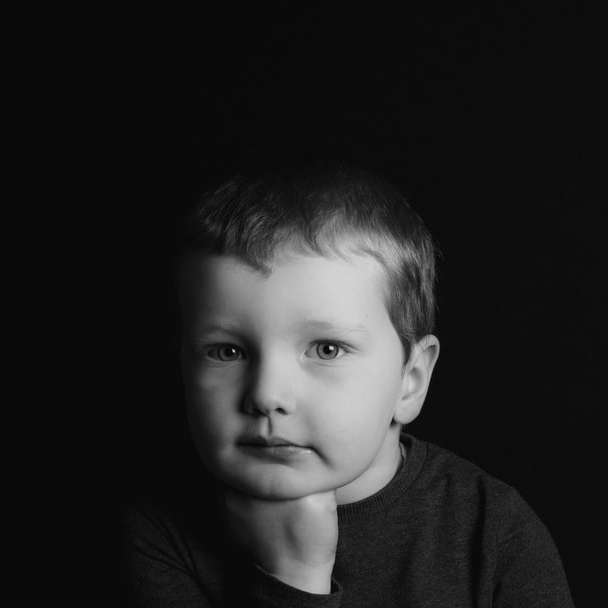 grayscale photo of boy in crew neck shirt sliding puzzle online