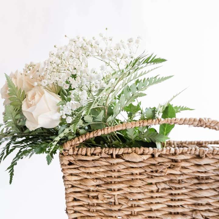 vita blommor på brun vävd korg glidande pussel online