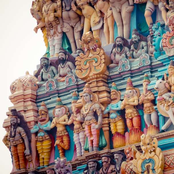 estátuas douradas e azuis de divindades hindus puzzle deslizante online