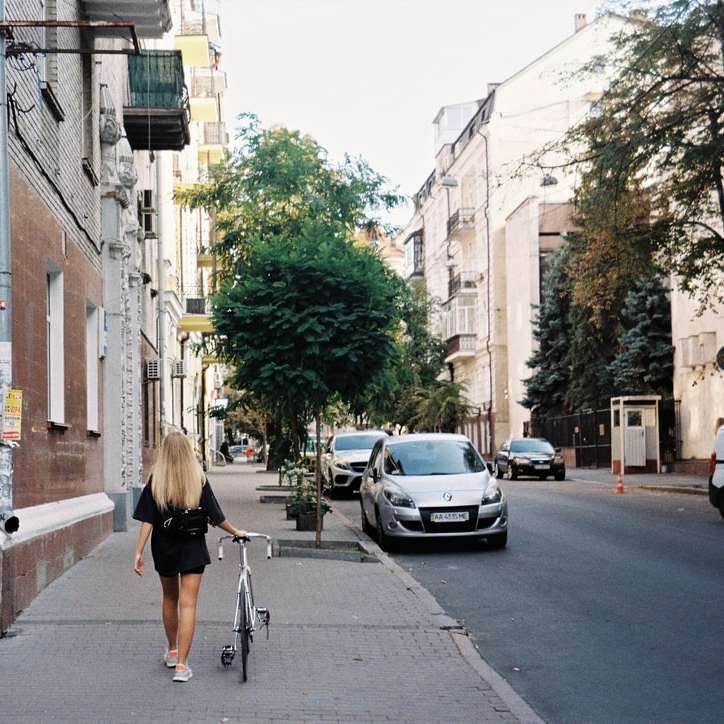 γυναίκα με μαύρο πουκάμισο και μαύρο σορτς περπάτημα στο πεζοδρόμιο συρόμενο παζλ online