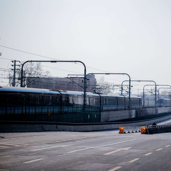 μπλε και άσπρο τρένο σε σιδηροδρομικό δρόμο κατά τη διάρκεια της ημέρας online παζλ