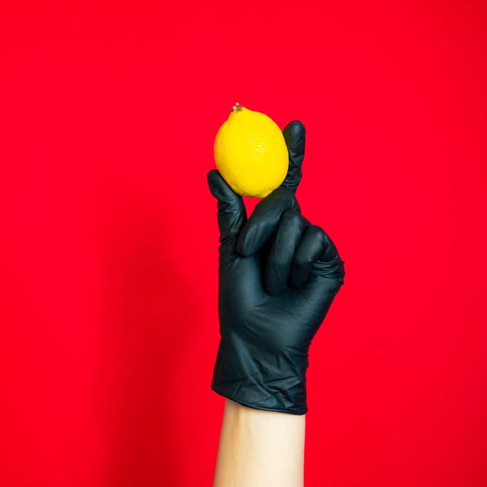 person holding yellow citrus fruit sliding puzzle online